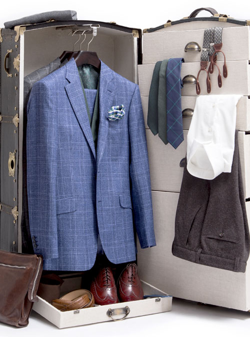 A travel trunk packed with a capsule wardrobe of tailored pieces
