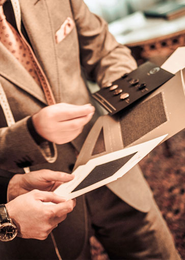 Choosing a cloth from a swatch book during a consultation